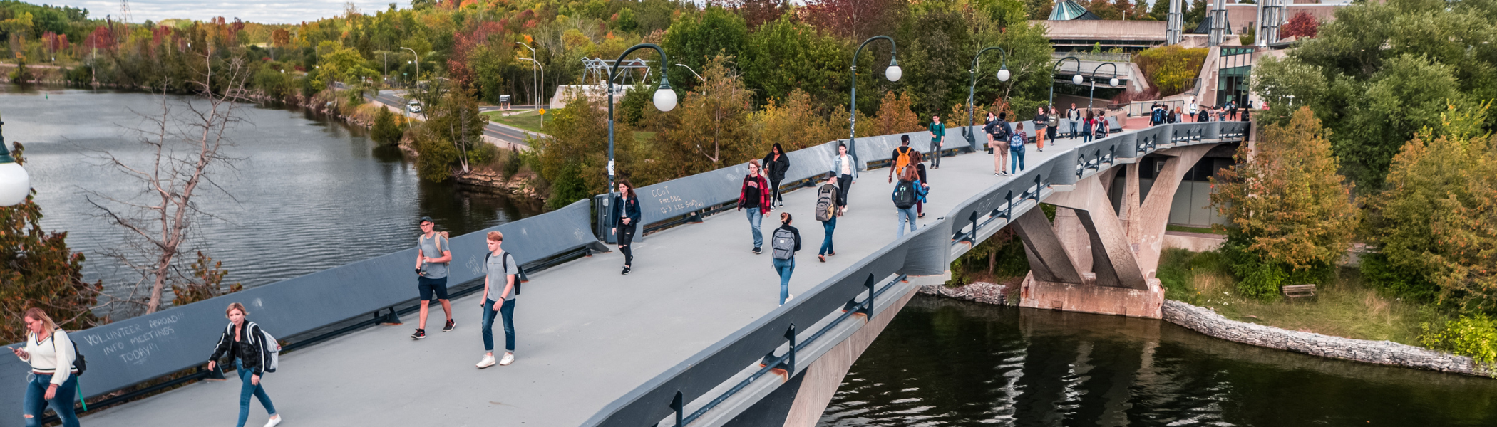 Students walking on bridge.