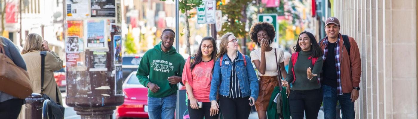 A group of six students walking downtown.
