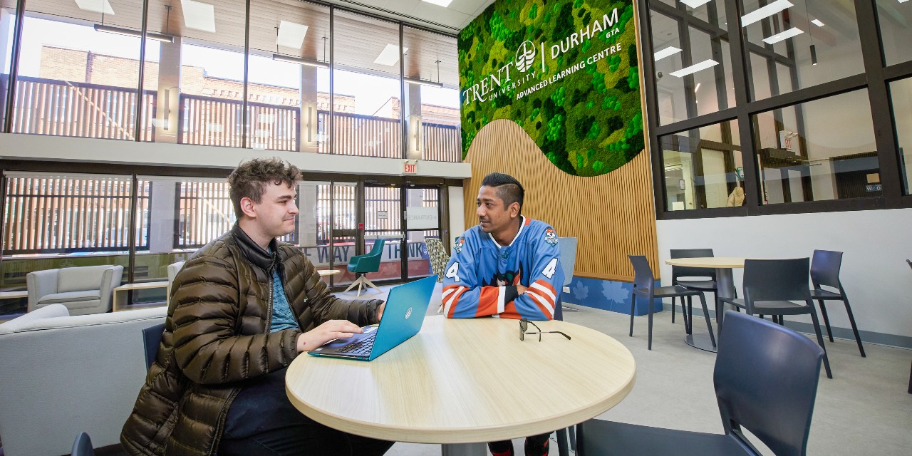 Two students studying in the lobby of Trent's Advanced Learning Centre
