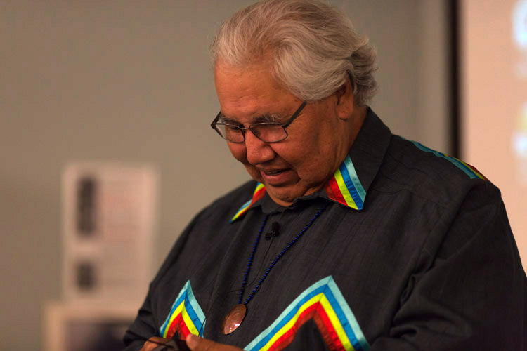 Murray Sinclair looking down in ribbon shirt.