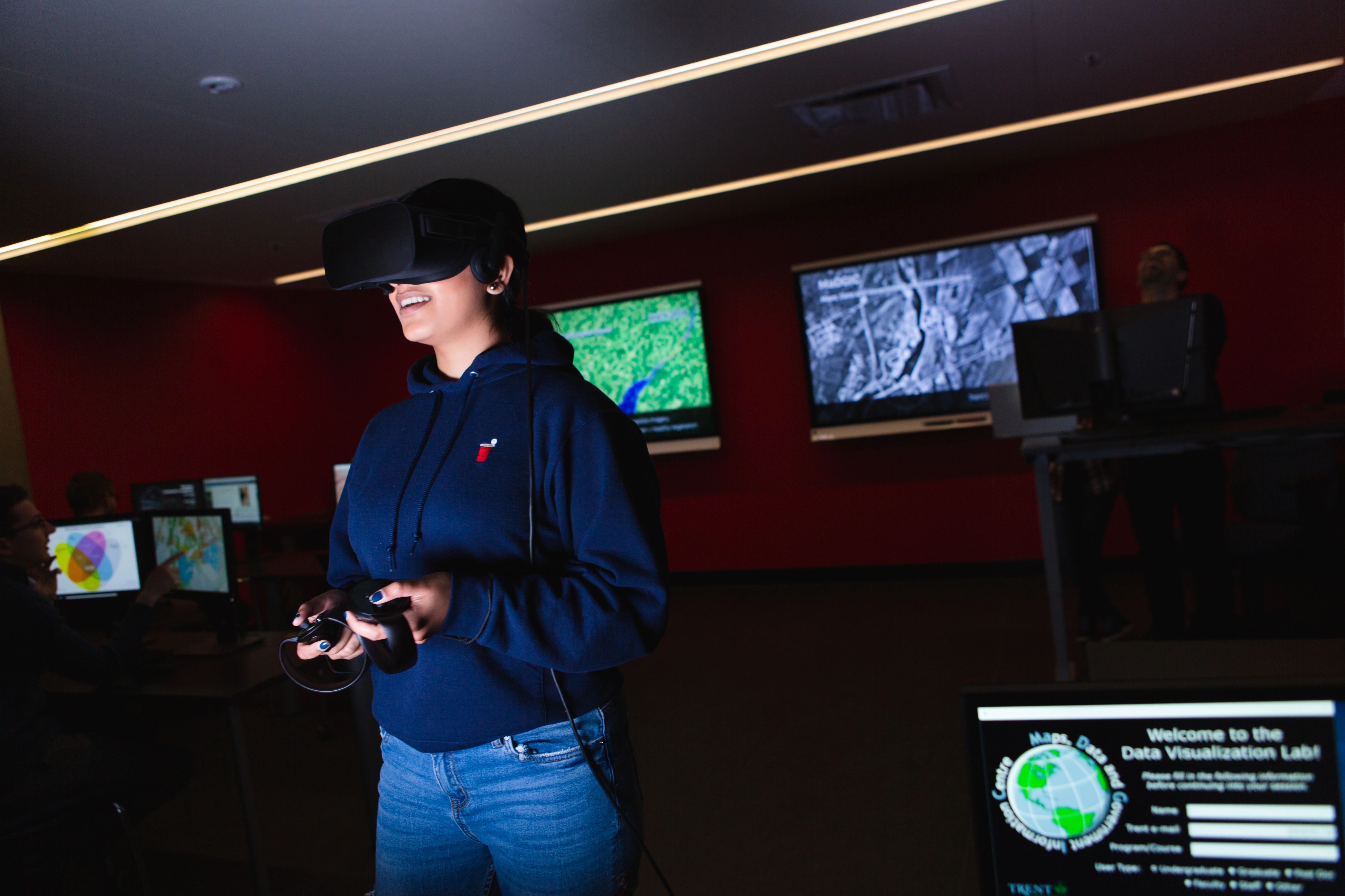 A person in a dark room with a virtual reality headset on their head.