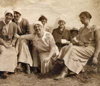 Sepia photograph of women in nurses uniform posed outside