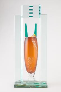 Tall glass sculpture, clear glass rectangular exterior with tall, orange, column in the center,