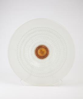 Circular glass plate, clear edges and bronze centre.